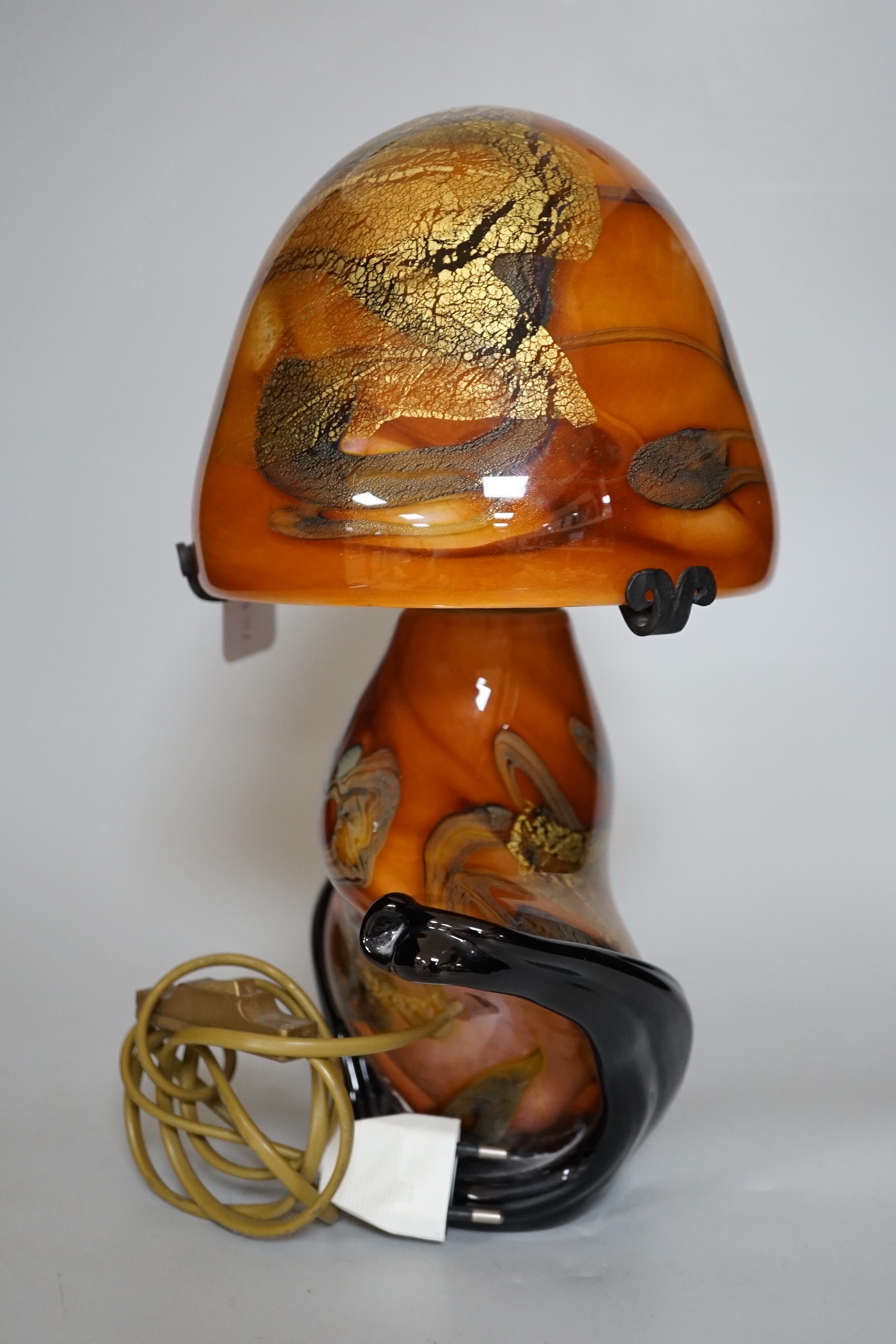 An indistinctly signed multi coloured art glass mushroom shaped table lamp, 35cm high